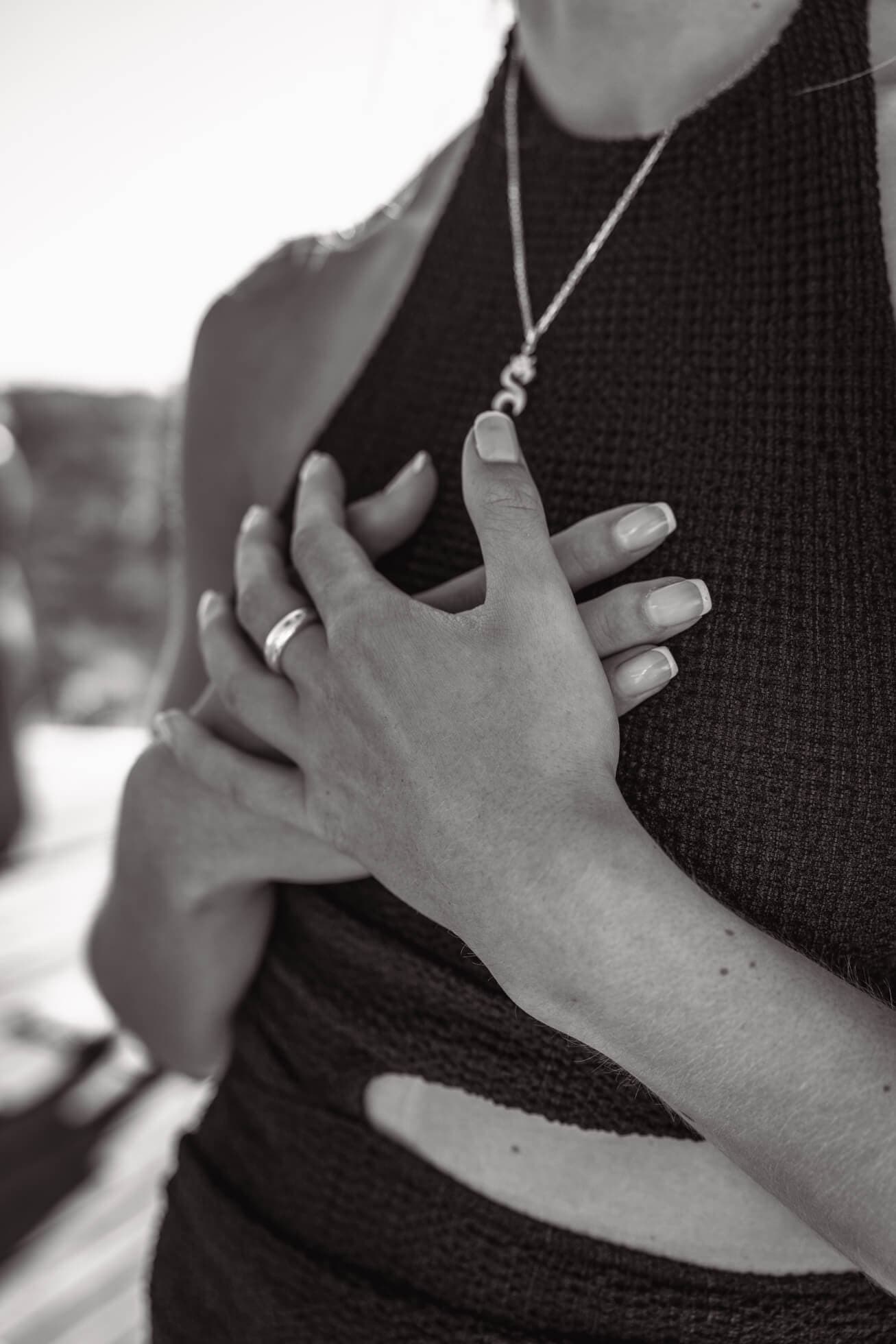 Close up photo of hands crossed on chest