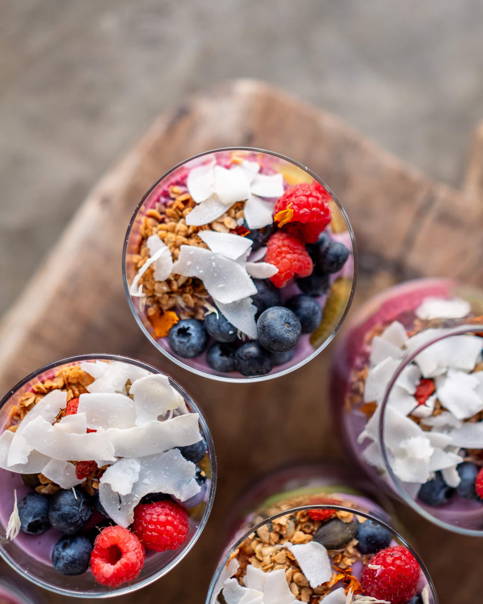 Top-down photo of 3 fruit and granola bowls